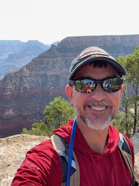 Ken Corriveau hiking at a canyon overlook